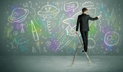 Young businessman drawing rocket