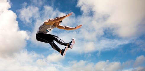 Composite image of portrait of sportsman jumping 