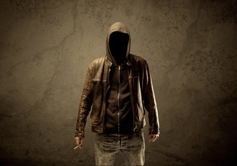 Naklejka na ściany i meble Undercover hooded stranger in the dark