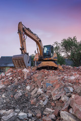 Excavator destroys old building