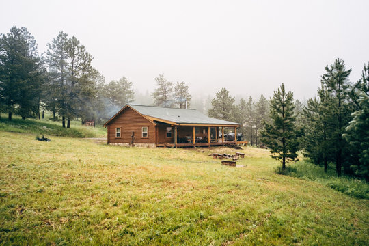 Log cabin with porch by forest