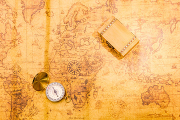 Vintage compass on map with treasure