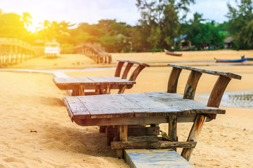 Obraz premium Empty wooden bench on beach. vintage filter