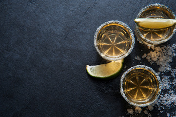 Tequila shots with lime slice, top view