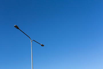 Electric light poles with big blue sky background with toned color and selective focus