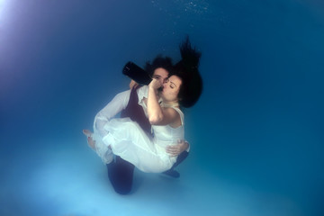 Bride and groom, underwater wedding in a pool