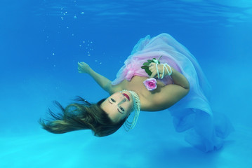  Woman presenting underwater fashion in pool