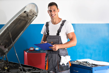 Mechanic writing on clipboard