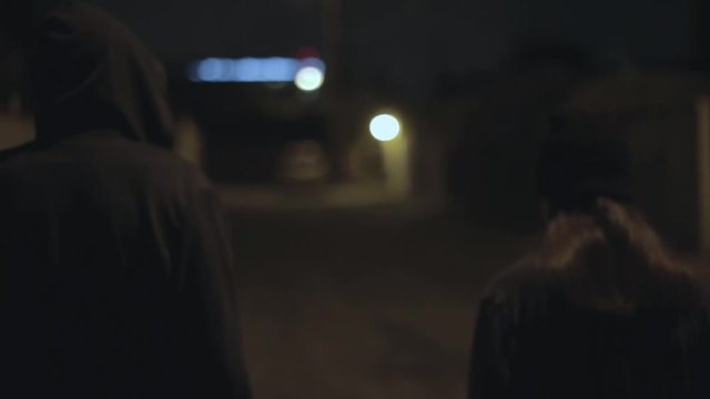 Teens Walk Through Alley At Night
