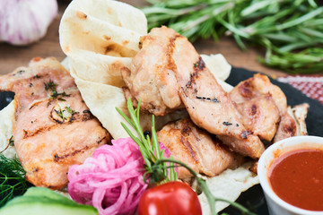 Fried bacon and zucchini with tzatziki sauce served on a stone Board closeup