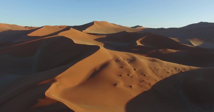 4K aerial view of endless sand dunes of the Namib desert inside the Namib-Naukluft National Park 