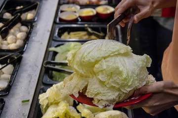 poeple  choosing food at  buffet in restaurant