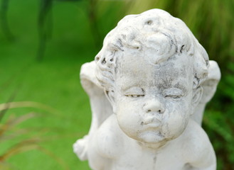 Fototapeta na wymiar cupid face sculpture stone