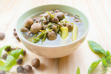 Thai mushroom soup with tamarind leaves.