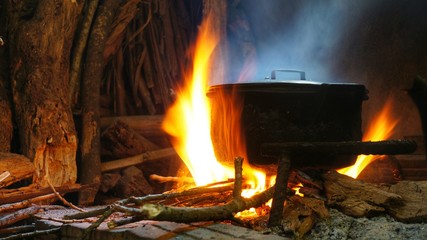 Hot pot on fire of burning wood