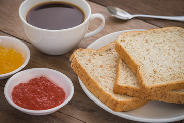 Whole wheat bread with jam and coffee cup