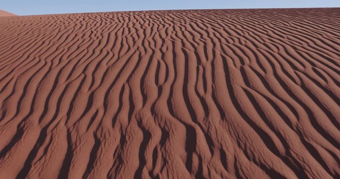 4K close-up moving shot of ripples in the surface of a sand dune inside the Namib-Naukluft National Park 