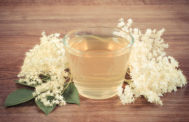 Vintage photo, Fresh healthy juice and elderberry flowers on rustic board