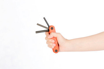 Hand holding screwdriver on white background, selective focus