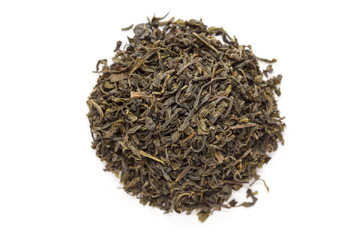 Organic Green Tea (Camellia sinensis) dried long leaves isolated on white background. Macro close up. Top view.