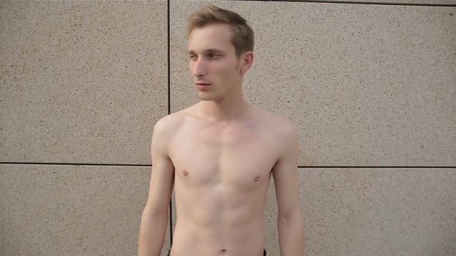 Man without a shirt posing for camera
