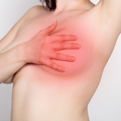 Breast cancer self check. Young woman examining her breast for lumps or signs of breast cancer. healthy lifestyle concept