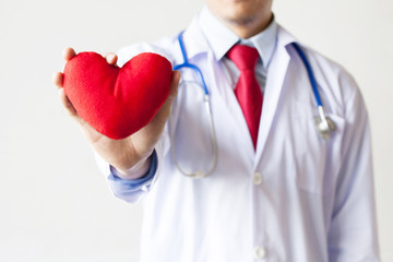 Doctor showing compassion and support holding red heart