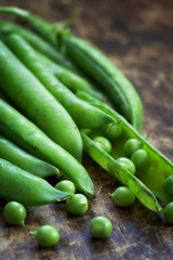Organic green peas on wooden table 