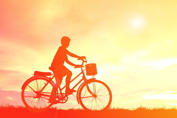 Silhouette children and bicycle at sunset