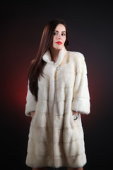 Beautiful model in fur coat white mink