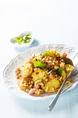 Fried potatoes with ham, onion, eggs and gherkin