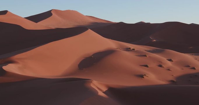 4K panning shot of the endless sand dunes of the Namib desert inside the Namib-Naukluft National Park