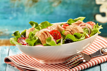 Delicious tuna fish salad in bowl with fork