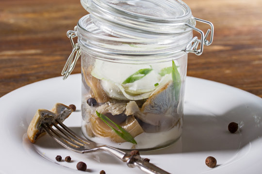 Salted Milk Mushrooms In A Glass Jar With Cream Sauce