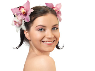 Naklejka premium Portrait of attractive woman with orchids in her hairstyle.