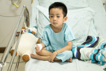 A sick Little boy in hospital bed.