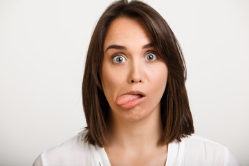 Fototapeta premium Portrait of girl playing ape over white background.