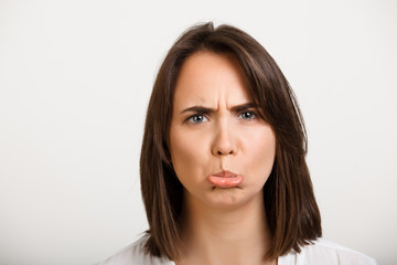 Portrait of girl playing ape over white background.