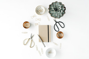 feminini desk workspace with succulent, scissors, diary and golden clips on white background. flat lay, top view