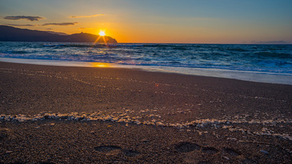 Obraz premium Sunrise at Tinderi beach with foodprints in the sand