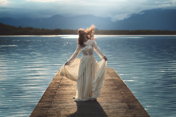 Young woman posing on lake pier