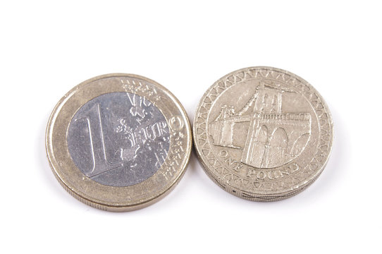 Great Britain Pound and Euro coin side by side isolated on the white background