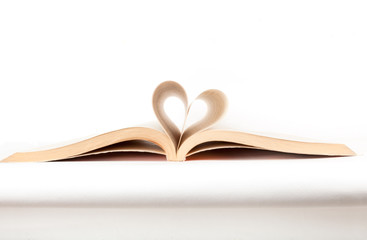 Heart shape from paper book isolated on background