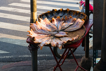 Cured, dried fish on a Bangkok street. Hawker food street stall on Asian town