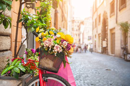 Fototapeta Bicycle with flowers in the old street in Rome, Italy