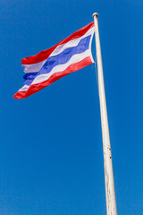 Image of waving Thai flag of Thailand with blue sky background