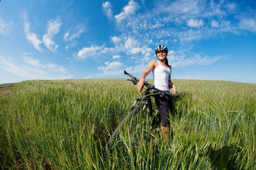 Happy Young Woman riding bicycle outside