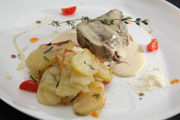 baked beef with sauce and potatoes