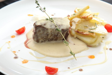 baked beef with sauce and potatoes