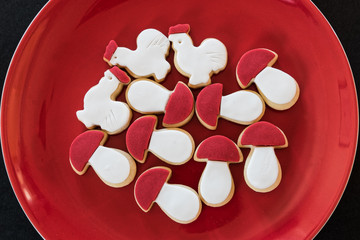 Homemade red and white butter cookies in red plate